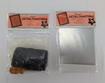 Puede incluir: Dos paquetes de suministros para punzonado de metales. Un paquete incluye un paquete de accesorios con un punzón, una almohadilla de fieltro negro y otros artículos. El otro paquete contiene una lámina de cobre de 12,7 cm x 12,7 cm. Ambos paquetes tienen el texto "ANKARAS METAL PUNCHING".