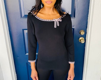 black sweater with bow on shoulder