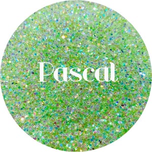 May include: A close-up of green glitter with iridescent sparkles. The word "Pascal" is written in white text on the glitter.