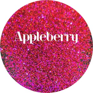 May include: A close-up of a red, pink, and purple glitter with a holographic finish. The glitter is labeled "Appleberry".