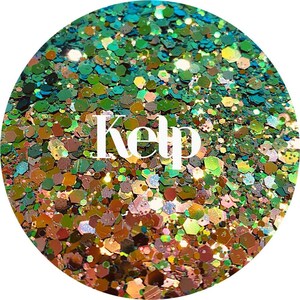 May include: A close-up of iridescent green, gold, and copper glitter with the word "Kelp" written in white text.
