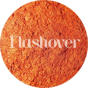 May include: A close-up of a bright orange powder with a fine texture. The powder is labeled "Flashover".
