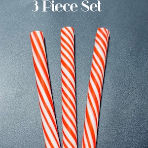 May include: Three red and white peppermint sticks, a 3 piece set.