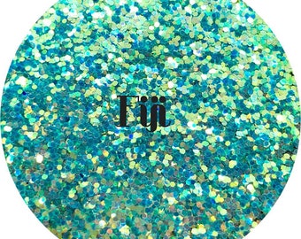 May include: A close-up of turquoise iridescent glitter with the word "Fiji" in black text.