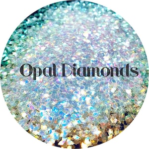 May include: A close-up of iridescent opal glitter, with a white background and the text "Opal Diamonds" in black.