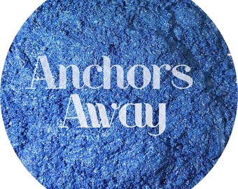 May include: A close-up of a blue glitter powder with the text "Anchors Away" in white.