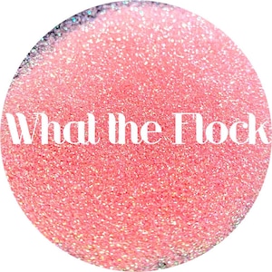May include: Pink glitter with iridescent shimmer. The glitter is in a round container with the text "What the Flock" in white.