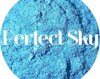May include: A close-up of a circular image with a textured, light blue surface. The words "Perfect Sky" are written in white script across the center of the image. The overall effect is a vibrant, eye-catching design.
