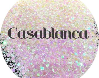 May include: A close-up of iridescent glitter in shades of white, pink, and blue. The glitter is labeled "Casablanca".