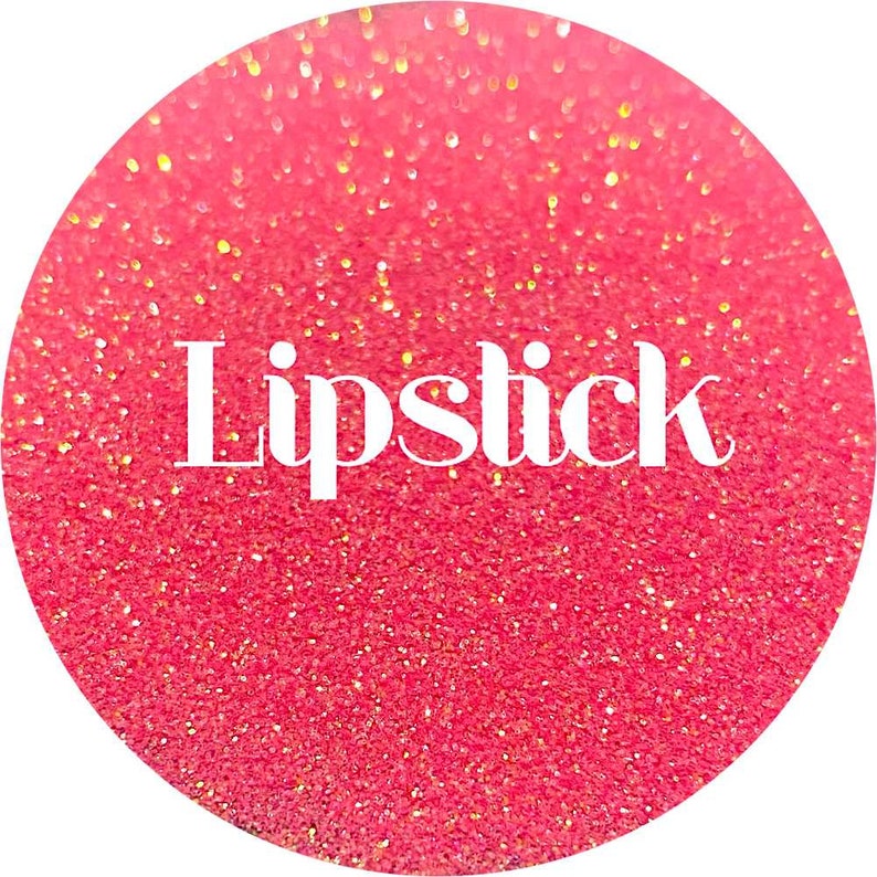 May include: A pink and gold glitter background with the word "Lipstick" in white text.