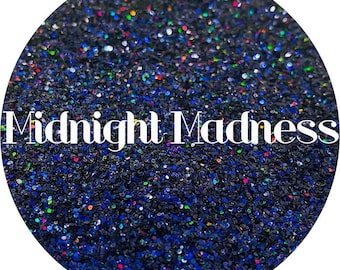 May include: A close-up of a dark blue glitter with iridescent sparkles. The glitter is called "Midnight Madness".