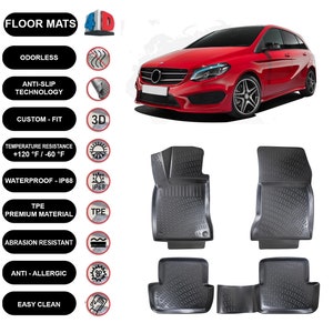 May include: Black car floor mats with a textured design. The image shows a red car and text highlighting features such as being odourless, anti-slip, custom fit, and waterproof. The mats are made of TPE premium material.