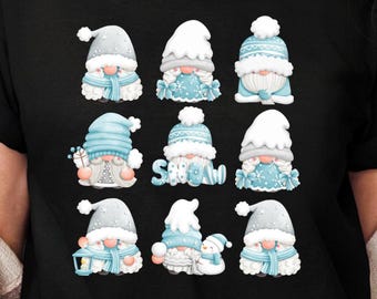 May include: A black t-shirt featuring a graphic print of nine winter gnomes arranged in a grid. The gnomes wear light blue and white hats, scarves, and winter clothing, with some holding lanterns or snowmen. The word SNOW is written in blue.
