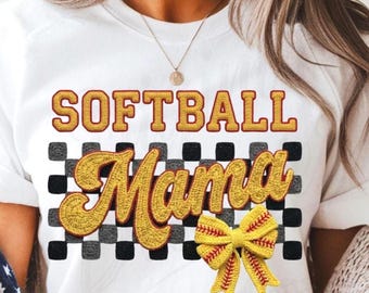 May include: White t-shirt with the words "SOFTBALL Mama" in yellow and gold embroidered lettering. A yellow softball bow is on the bottom right. The background has a black and gray checkered pattern.
