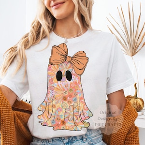 A cute retro floral aghast png design and oversized orange bow, ideal for girly halloween shirts and sublimation projects