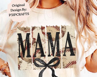 May include: A cream-colored t-shirt featuring a graphic print of the word MAMA in large black letters. The design includes a background of baseballs with red stitching and a black bow graphic at the bottom. The text Original Design By: P31PCRAFTS is visible.