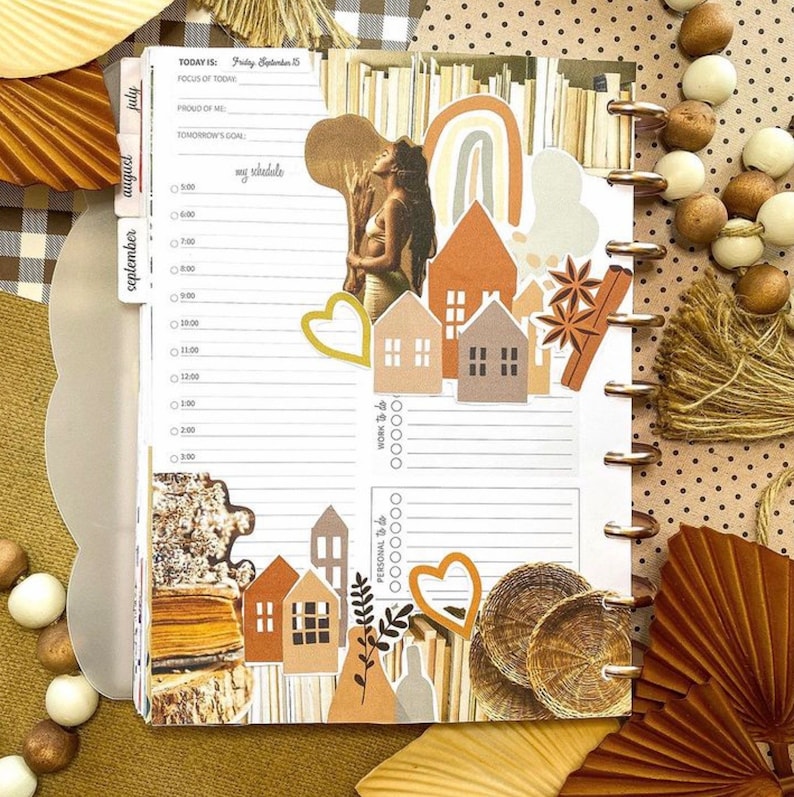 May include: A weekly planner with a brown and white color scheme. The planner has a tab for each month, with the current month being September. The planner is decorated with various stickers, including houses, hearts, and leaves. The text "TODAY IS: Friday September 15" is at the top of the page. The planner is open to the daily schedule page.