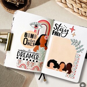 May include: A colorful planner page with stickers and washi tape. The stickers include a rainbow, an eye, a flower, and a woman's face. The text on the page says "boho vibes only", "stay free", and "dreamer".