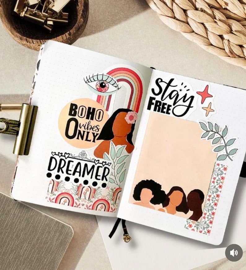 May include: A colorful planner page with stickers and washi tape. The stickers include a rainbow, an eye, a flower, and a woman's face. The text on the page says "boho vibes only", "stay free", and "dreamer".
