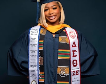 May include: A graduate in a navy blue cap and gown with a gold stole. The graduate wears a sash with the Greek letters Delta, Sigma, and Theta, and a sash with the name "Shayla Mone't Harris". The image includes text that reads "Bachelor of Science Computer Science".