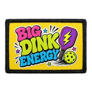 May include: A rectangular patch with a yellow background and a black border. The text BIG DINK ENERGY is displayed in large, colorful, comic-style letters. A purple pickleball paddle with a yellow lightning bolt and a yellow ball are included.