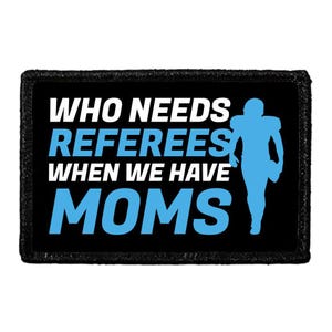 May include: A rectangular black patch with a stitched border featuring the white and light blue text WHO NEEDS REFEREES WHEN WE HAVE MOMS. To the right of the text is a light blue silhouette of a football player in a helmet and uniform.