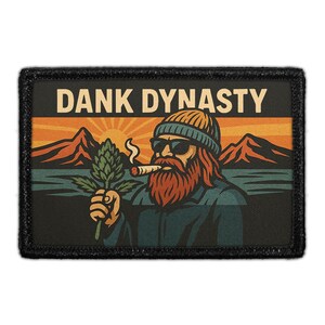 May include: Rectangular patch with the text "DANK DYNASTY" above an illustration of a bearded man in sunglasses and a beanie, holding a cannabis plant and smoking a cigar. The background features a sunset over mountains and a lake.