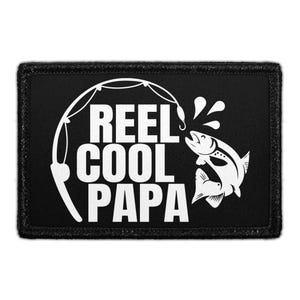 May include: Black rectangular patch with white text and graphic. The text reads "REEL COOL PAPA" with a fishing rod and a jumping fish. The patch has a black border.
