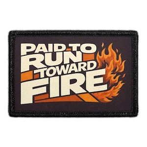 May include: Rectangular patch with the text "PAID TO RUN TOWARD FIRE" in white and orange, set against a dark background. The design includes stylized flames in shades of orange and yellow. The patch has a black border.