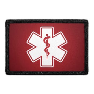 May include: A rectangular patch featuring the Star of Life symbol, a white six-pointed star with a staff and serpent in the center, on a red background. The patch has a black border, commonly used for medical and emergency services.
