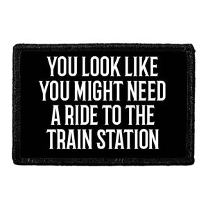 May include: A rectangular black patch with a stitched border featuring the white text: YOU LOOK LIKE YOU MIGHT NEED A RIDE TO THE TRAIN STATION. The design is centered on the black background with bold, sans-serif capital letters throughout.