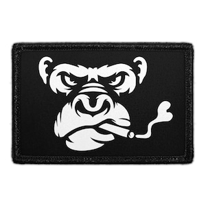 May include: A rectangular patch featuring a white gorilla face smoking a cigar on a black background. The gorilla has a stern expression. The patch has a black border.