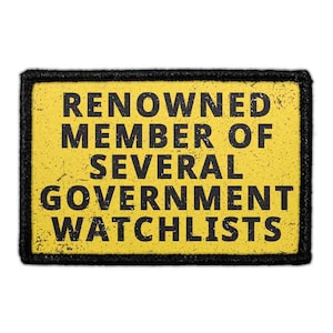 May include: A rectangular patch with a yellow background and a black border. The text "RENOWNED MEMBER OF SEVERAL GOVERNMENT WATCHLISTS" is printed in black, distressed, sans-serif capital letters across the center of the patch.