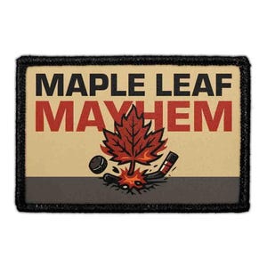 May include: A rectangular embroidered patch with a black border featuring the text MAPLE LEAF MAYHEM in black and red. The design includes a central red maple leaf, a black hockey puck, and a black hockey stick on a light tan background.