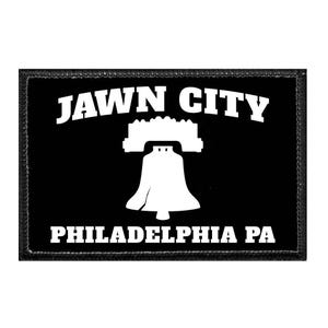 May include: A rectangular black patch with a white embroidered border. The design features the white text JAWN CITY arched above a white graphic of the Liberty Bell, with the white text PHILADELPHIA PA centered below the bell icon.
