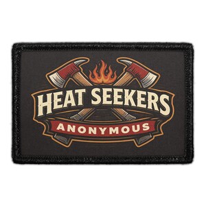 May include: A rectangular black patch featuring a graphic of two crossed axes behind a stylized orange flame. The text HEAT SEEKERS is printed in large cream letters above a red banner containing the word ANONYMOUS in white capital letters.