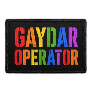 May include: A rectangular black patch with a stitched border featuring the text GAYDAR OPERATOR in a distressed, multi-colored font. The letters transition through a rainbow spectrum of red, orange, yellow, green, blue, and purple colors.