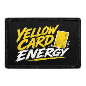 May include: A rectangular black patch with a stitched border featuring the yellow text YELLOW CARD and the white text ENERGY. A yellow rectangular card icon with a distressed texture is positioned to the right of the word CARD.