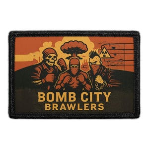 May include: A rectangular patch with a black border features a graphic of three figures in a post-apocalyptic scene. The figures include a skull, a masked person, and a person with a mohawk. The text "BOMB CITY BRAWLERS" is displayed in bold letters.