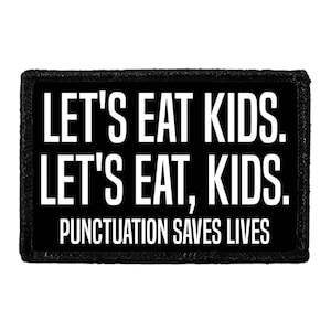 May include: A rectangular black patch with white text that reads: LET'S EAT KIDS. LET'S EAT, KIDS. PUNCTUATION SAVES LIVES. The patch features a thick black border and a clean, sans-serif font, highlighting the importance of grammar in communication.