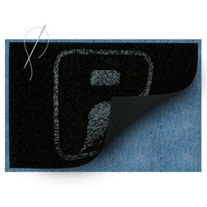 May include: A rectangular black patch with a textured surface featuring a stylized letter F in a lighter gray outline. The patch has a corner folded over to reveal a smooth black underside, and it is placed against a blue denim fabric background.