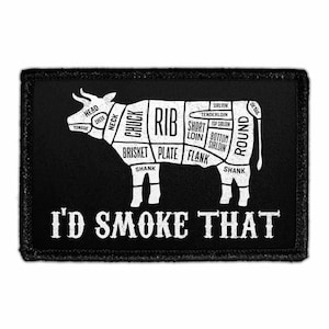 May include: Black patch with a white diagram of a cow, labeled with different cuts of meat. Text at the bottom reads "I'D SMOKE THAT". The patch is rectangular with a black border.