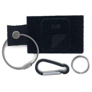 May include: A black key chain with a black fabric patch, a silver cable chain, a silver carabiner clip, and a silver key ring.
