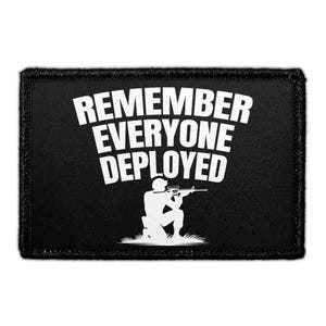 May include: A rectangular black patch with a white embroidered border. The patch features the white text REMEMBER EVERYONE DEPLOYED arched over a white silhouette of a soldier in a kneeling position aiming a rifle with a scope attached.