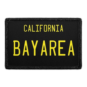 May include: Black rectangular patch with yellow text that reads "CALIFORNIA BAYAREA". The patch has a black border and is likely made of fabric. The text is in a bold, sans-serif font.