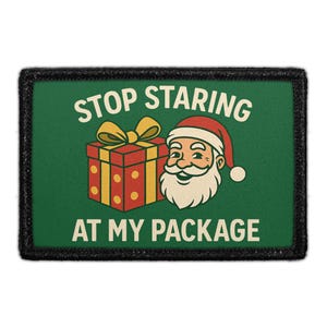 May include: A rectangular patch with a dark green background and a black border. It features a red gift box with a yellow ribbon and a smiling Santa Claus head. The text reads STOP STARING AT MY PACKAGE in cream-colored capital letters.