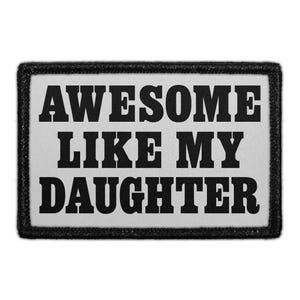 May include: A rectangular embroidered patch with a light gray background and a thick black border. The text AWESOME LIKE MY DAUGHTER is stitched in bold, black, capital letters across the center of the patch in a classic serif font style.