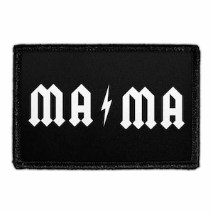 May include: Black rectangular patch with white text that reads "MA ⚡ MA". The text is in a gothic font style, with a lightning bolt symbol between the two words. The patch has a black border.