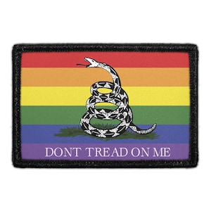 May include: Rectangular patch with a black border featuring a rainbow background and a coiled snake illustration. The snake is black and white, with its tongue extended. The text "DONT TREAD ON ME" is at the bottom.
