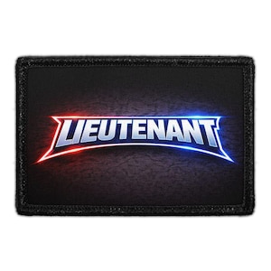 May include: A rectangular black patch with a stitched border featuring the word LIEUTENANT in bold white capital letters. The text is underlined by a glowing arc that transitions from red on the left side to blue on the right side.